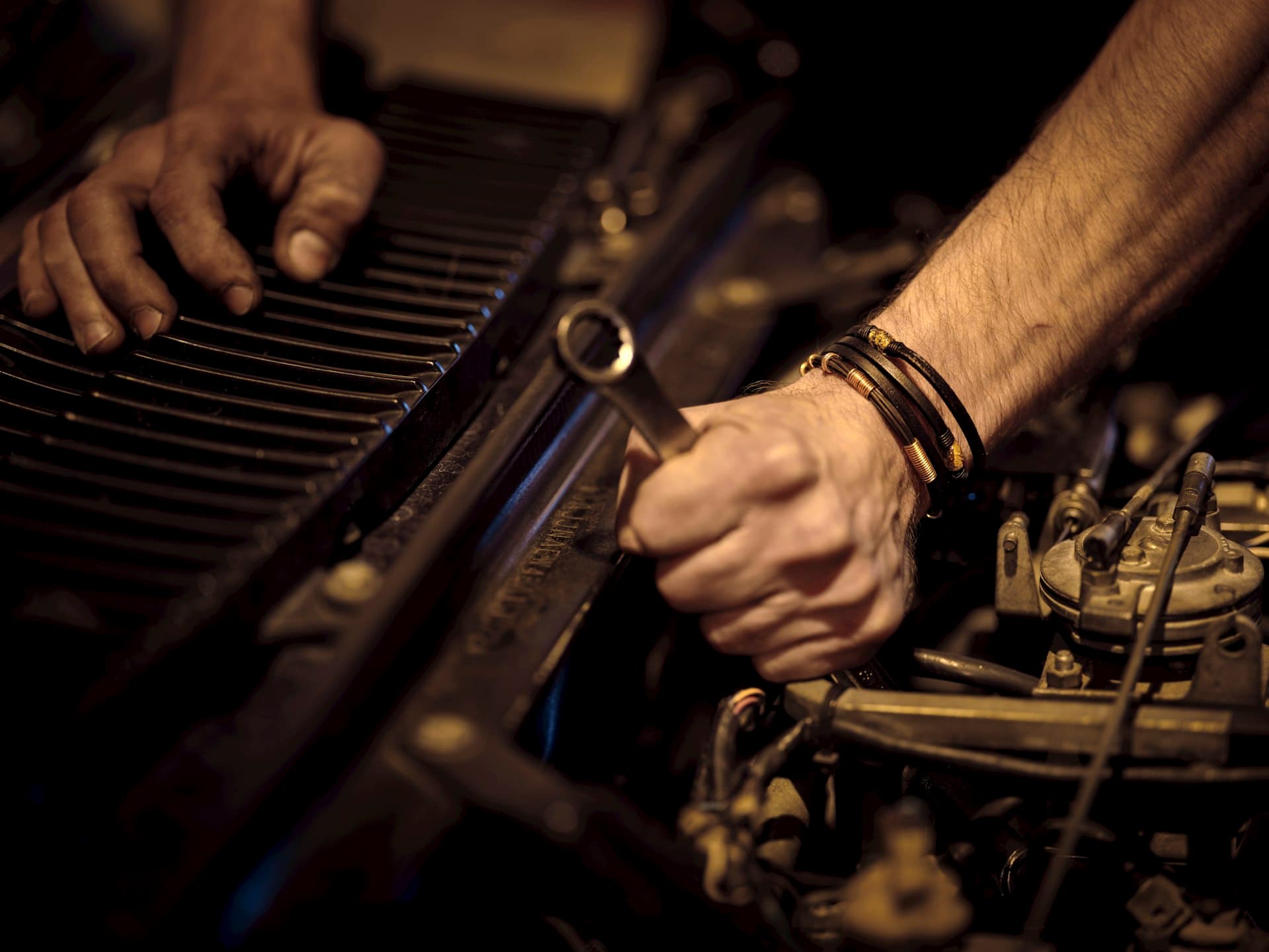 Mechanic inspecting brakes and fitting tires on a vehicle