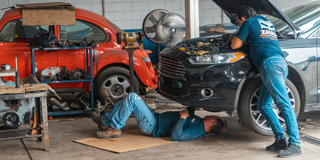 Workshop team servicing a vehicle on the shop floor