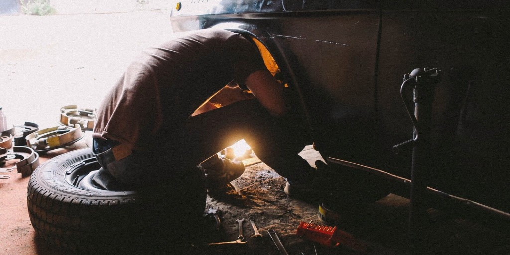 Technician working on wheel and suspension components